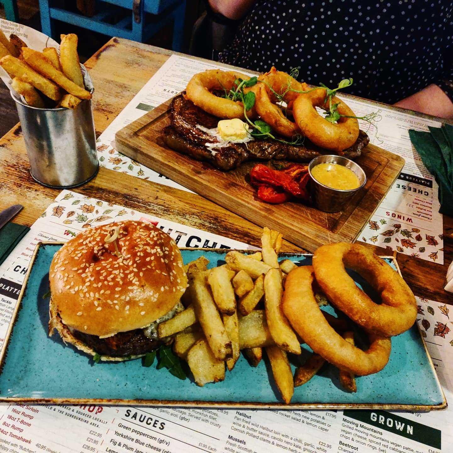 A rump steak served with onion rings and a Porterhouse steak burger from Butcher and Catch